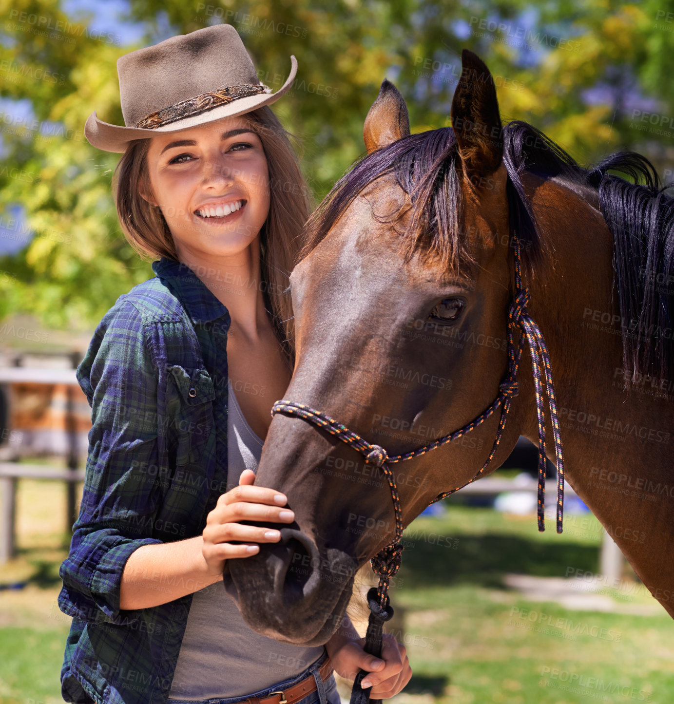 Buy stock photo Portrait of a young cowgirl standing with her horse