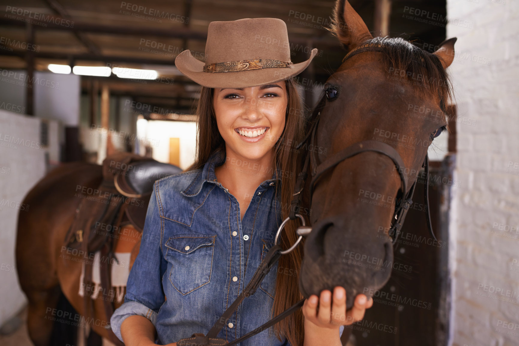 Buy stock photo Shot of a young woman tending to her horse