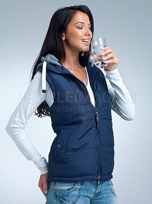 Buy stock photo Woman, water for health and hydration in studio, nutrition and wellness with drink for thirst on grey background. Liquid, aqua and mineral with h2o in glass, fresh and clean for refreshment and detox