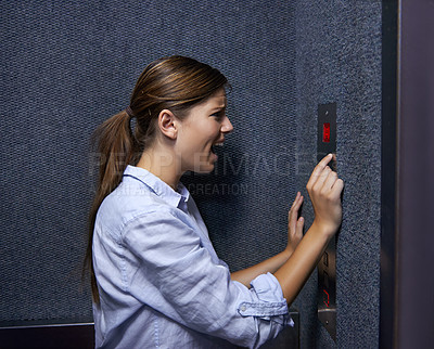 Buy stock photo Shot of a fearful woman shouting into an elevator intercom