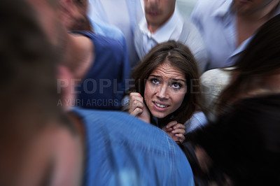 Buy stock photo Shot of a fearful young woman feeling trapped by the crowd