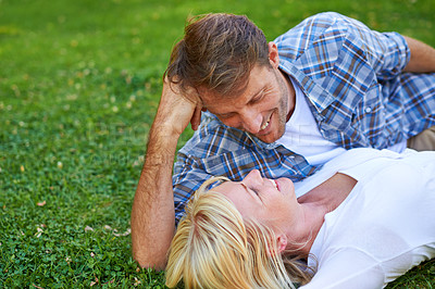 Buy stock photo Couple, smile and relax on grass field or love connection on nature holiday or anniversary, marriage or sunshine. Man, woman and lying in backyard garden in Florida or happiness date, outdoor or calm