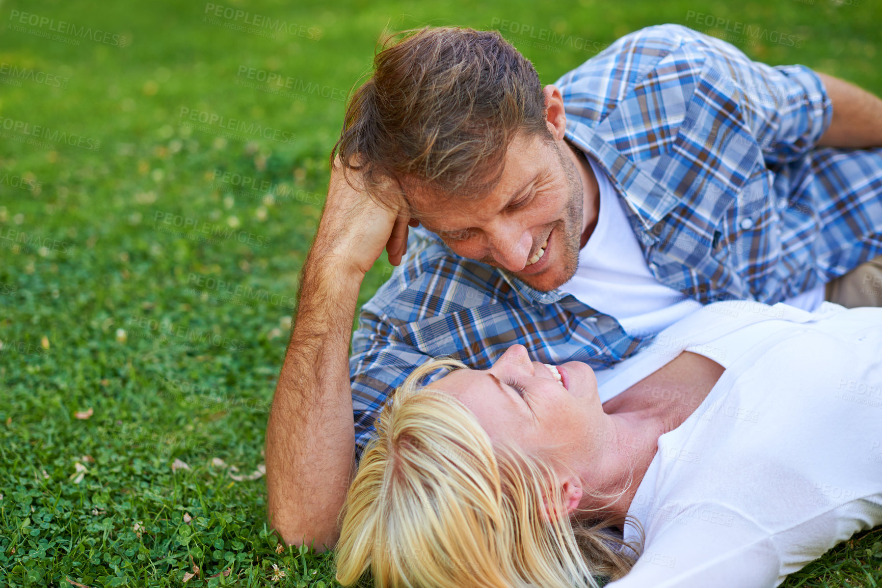Buy stock photo Couple, smile and relax on grass field or love connection on nature holiday or anniversary, marriage or sunshine. Man, woman and lying in backyard garden in Florida or happiness date, outdoor or calm