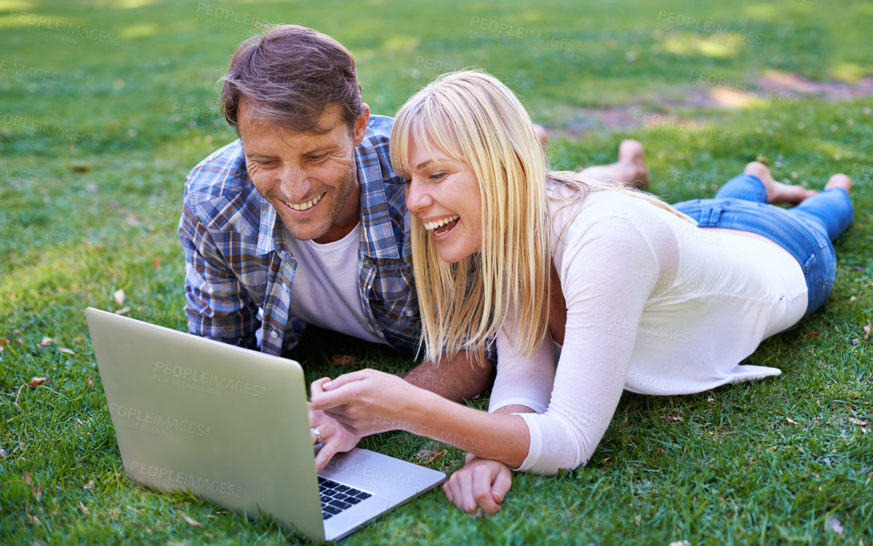 Buy stock photo Love, laugh or couple with laptop in nature for social media, video or streaming comic outdoor Computer, google it or people in backyard online for show search, sign up or netflix and chill on grass