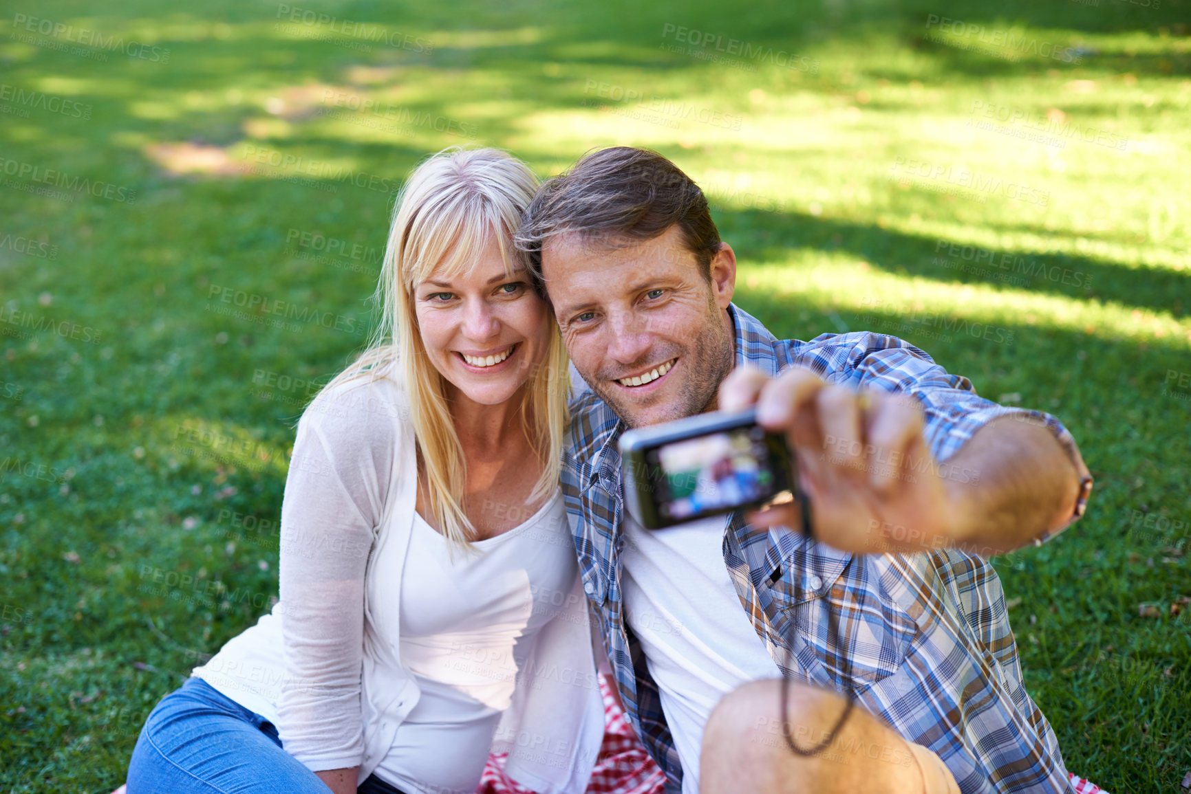 Buy stock photo Selfie, camera and couple in a park, love and happiness with marriage and romance with summer or nature. Photograph, outdoor or memory with man or woman with relationship, relax or date with sunshine