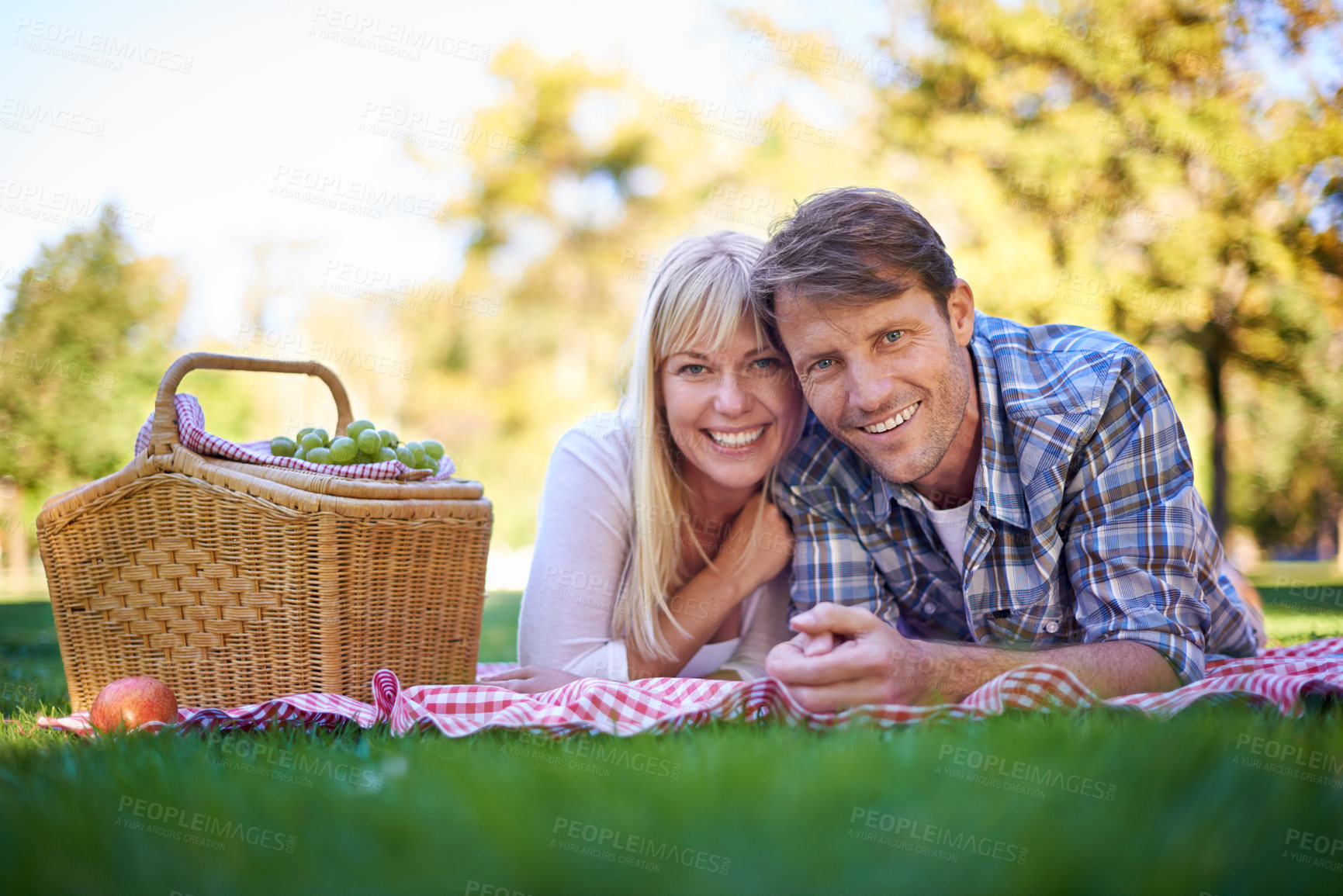 Buy stock photo Happy couple, portrait and smile at park picnic or fruit basket for holiday snack for relationship, travel or relax. Man, woman and face in nature together in Florida or vacation, nutrition or meal