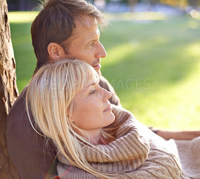 Buy stock photo Couple, park and relax by tree in embrace, romance and bonding for love at park on weekend trip. People, care and outdoor date for relationship or marriage, support and hug in nature for commitment
