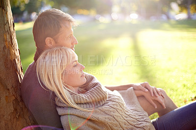 Buy stock photo Couple, park and relax by tree in hug, romance and bonding for love at park on weekend trip. People, lovers and outdoor date for relationship or marriage, support and embrace in nature for commitment