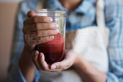 Buy stock photo Hands, glass and juice with kitchen, closeup and person with smoothie for health and wellness. Chef, drink and beverage for nutrition, vitamins and vitality for juicing diet with apron at home