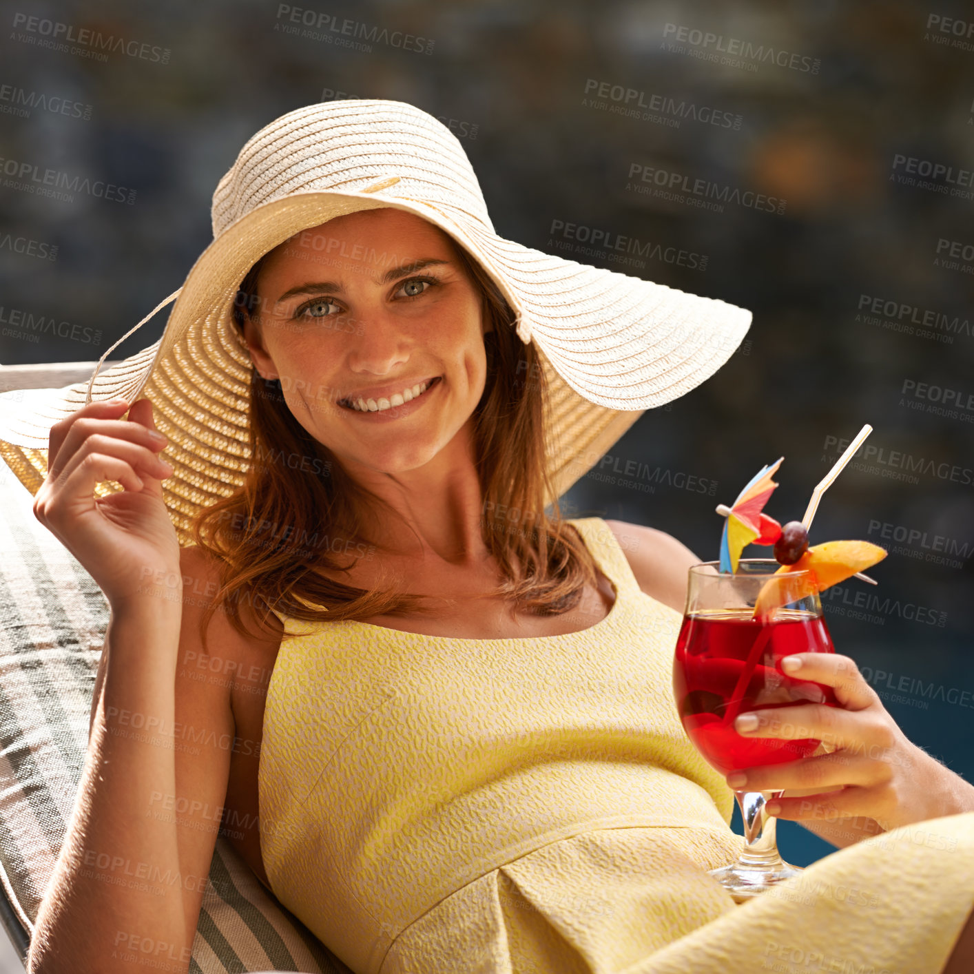 Buy stock photo Woman, cocktail and glass by swimming pool on lounge chair for summer, holiday and tropical vacation. Young person or tourist in portrait by hotel with hat, drink or alcohol for happy, outdoor break