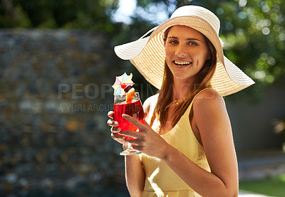 Buy stock photo A woman standing outdoors enjoying a cocktail