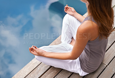 Buy stock photo Cropped closeup of a young woman meditating poolside