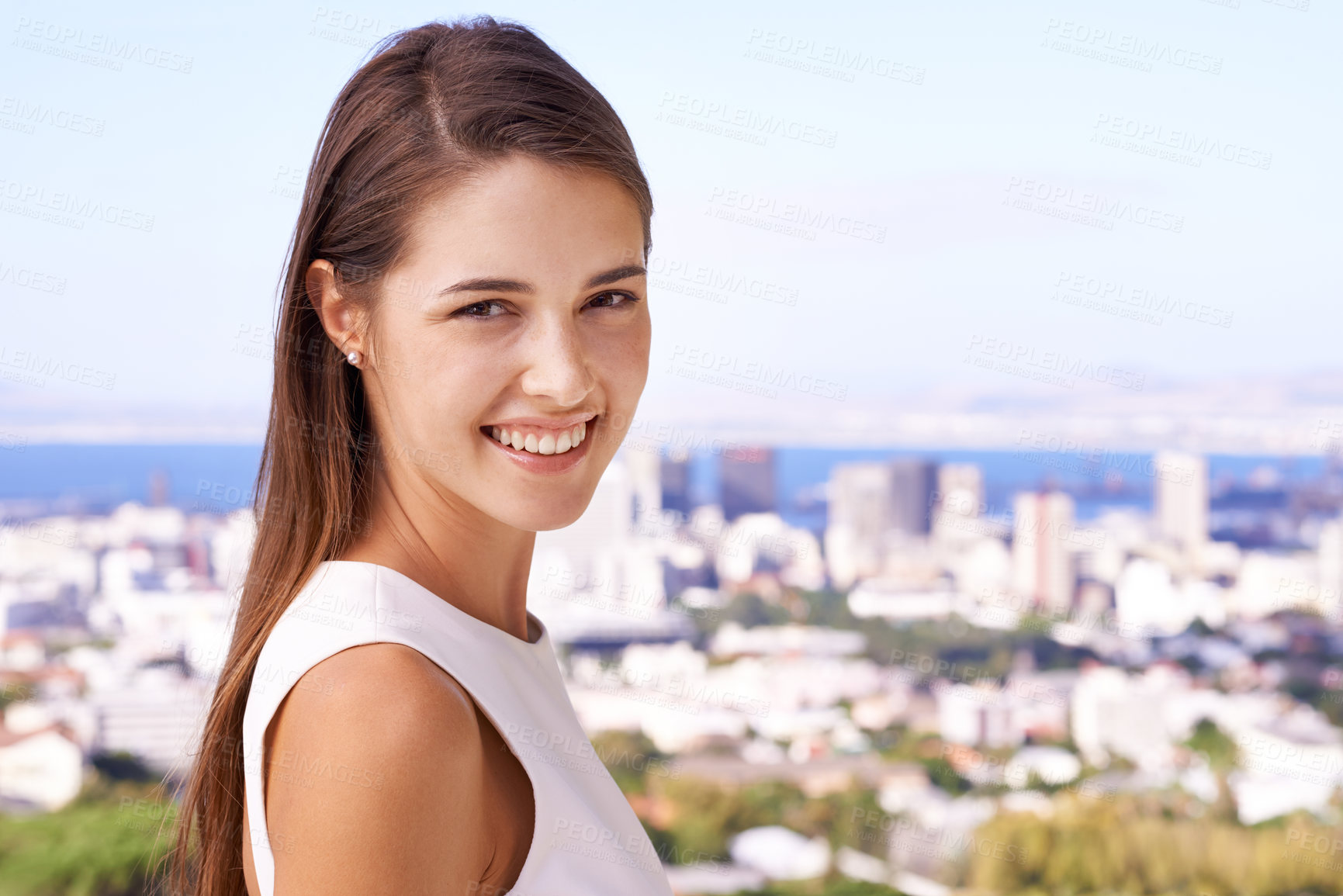 Buy stock photo Woman, smile and portrait in outdoor or city for travel, vacation or view for cityscape and buildings on balcony. Young person, happy and Cape Town with sea and summer for sky on an urban terrace