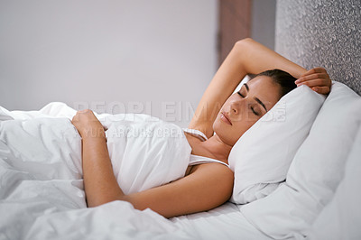 Buy stock photo Bedroom, sleep and woman in bed at house, home and hotel to relax, rest and dreaming with duvet in Cape Town. Female person, lady and tired with pillow, blanket and eyes closed comfortable in nap
