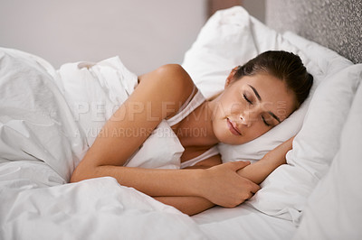 Buy stock photo Shot of a beautiful young woman sleeping in her bed
