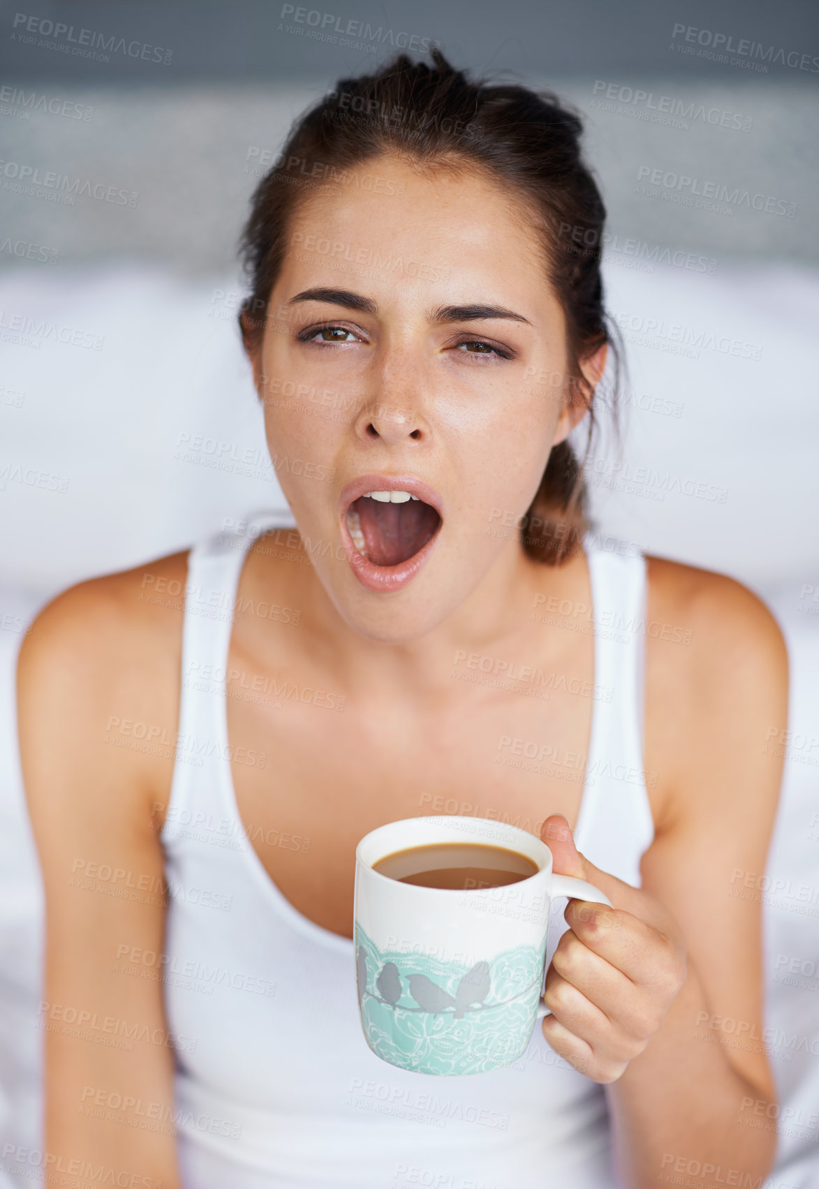 Buy stock photo Woman, tired and yawning with tea in bed, waking up from sleeping or nap with morning routine at home. Insomnia, fatigue and sleepy in bedroom, warm drink or beverage for breakfast and start day