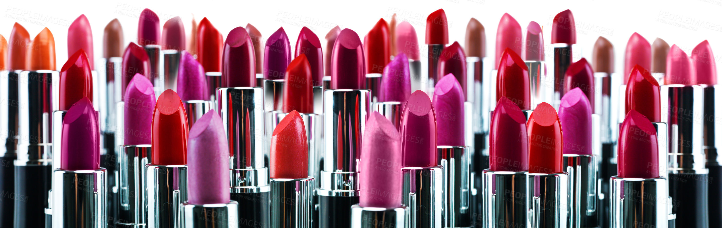 Buy stock photo A studio shot of many different colored lipsticks