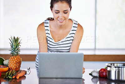 Buy stock photo Woman, thinking and laptop on kitchen counter, happy female person and home on internet. Google it, browsing cooking recipes and social media, online search on technology for healthy food ideas
