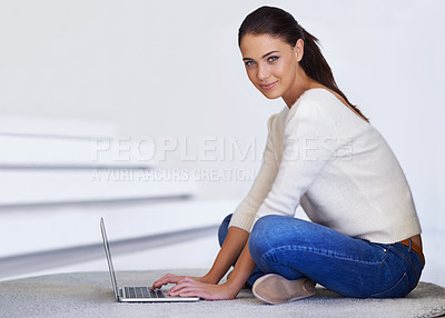 Buy stock photo A beautiful young woman sitting on her floor  and using a laptop