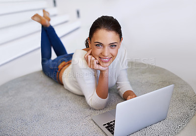 Buy stock photo A beautiful young woman sitting on her floor  and using a laptop