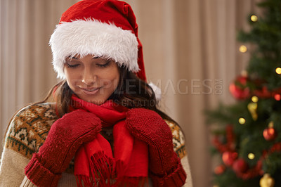 Buy stock photo Christmas, face or smile and woman in living room of home with Santa hat, scarf and gloves for winter. Celebration, December and holiday with happy young person in apartment for festive season
