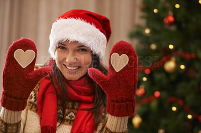 Buy stock photo Portrait of an attractive young woman showing you her Christmas gloves