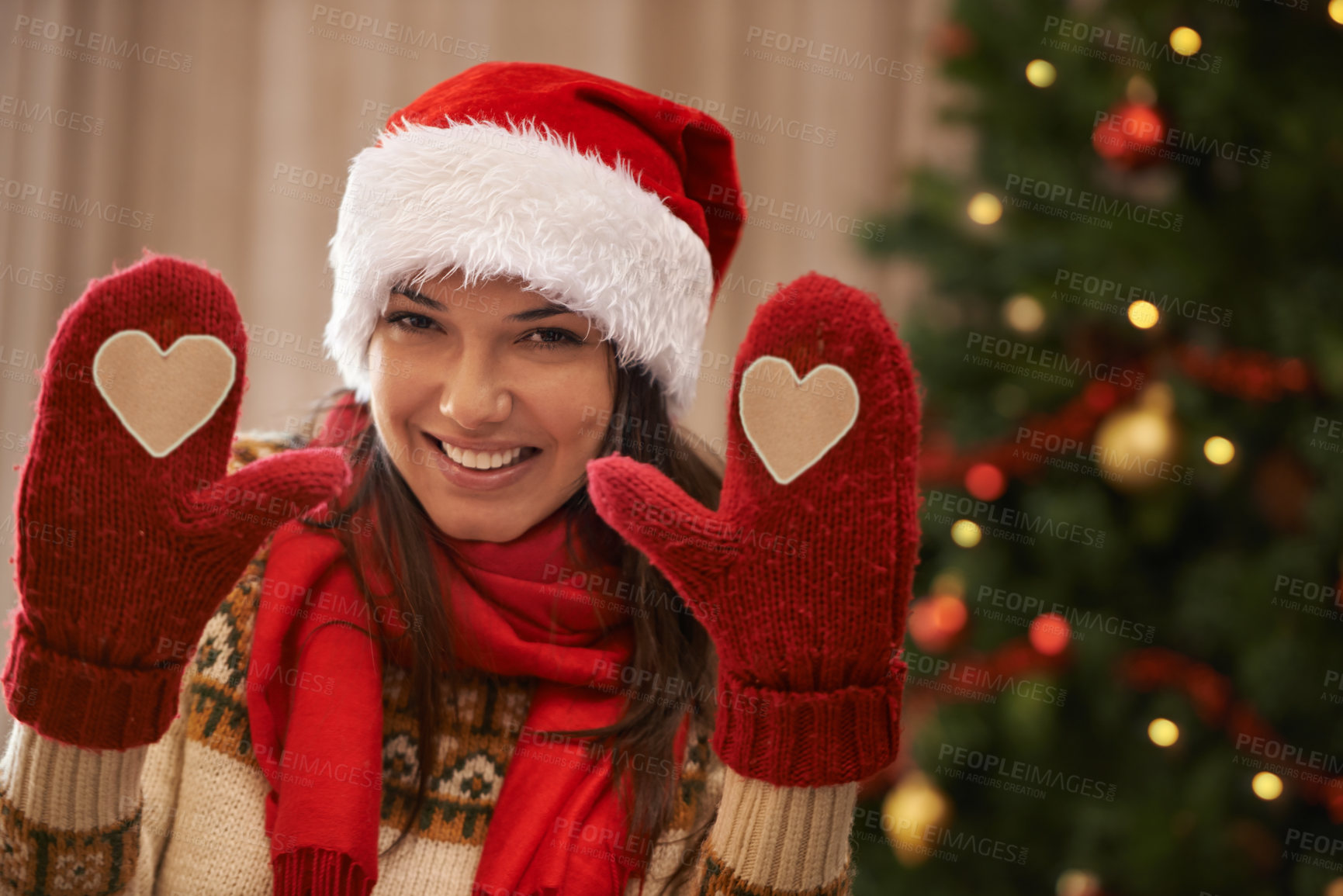 Buy stock photo Portrait of an attractive young woman showing you her Christmas gloves