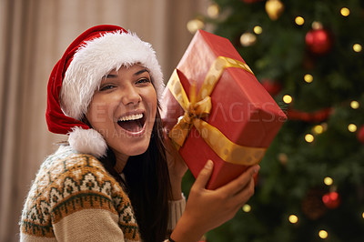 Buy stock photo Christmas, excited and portrait of woman with present at her home for festive celebration, event or party. Smile, happy and young female person with gift box for xmas surprise in living room at house