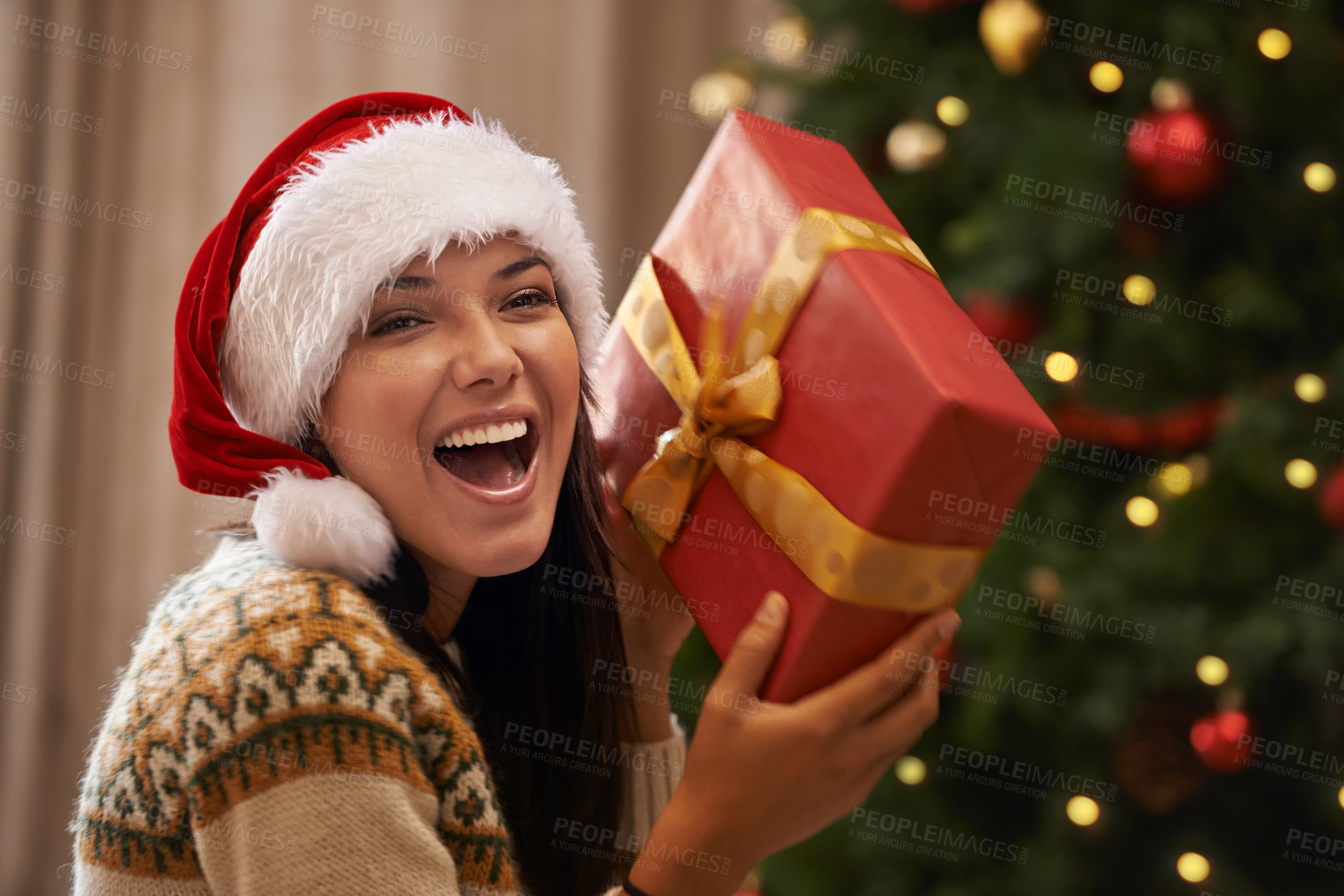 Buy stock photo Christmas, excited and portrait of woman with present at her home for festive celebration, event or party. Smile, happy and young female person with gift box for xmas surprise in living room at house