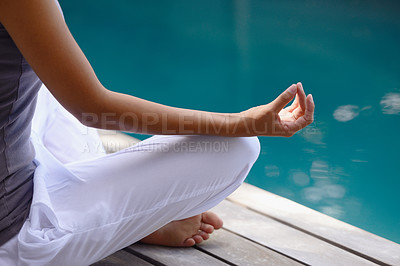 Buy stock photo Cropped shot of a relaxed young woman meditating by the poolside