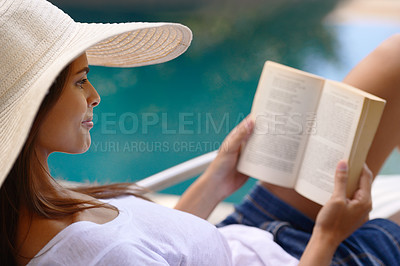 Buy stock photo Vacation, relax and woman at pool with book, hat and lounge with happy summer travel on hotel patio. Holiday, deck chair and girl with smile, reading and story with sunshine, weekend or luxury resort