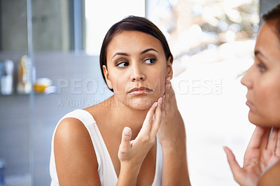Buy stock photo Worried, woman and skincare in mirror pimple or face spot or acne on cheek. Female person, unhappy or sad and reflection in bathroom for lotion, self care and glowing skin as daily routine
