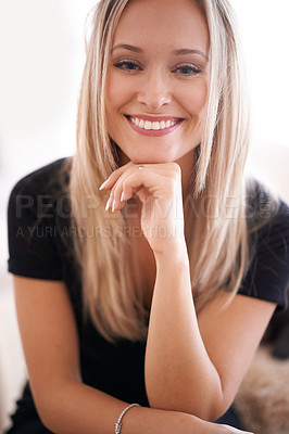 Buy stock photo Portrait of a young woman sitting with her hand on her chin