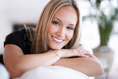 Buy stock photo Portrait of a young blonde woman relaxing on the sofa at home