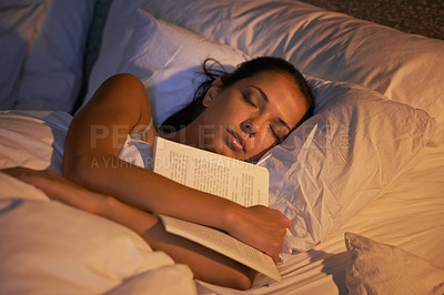 Buy stock photo Shot of an attractive young woman sleeping holding book
