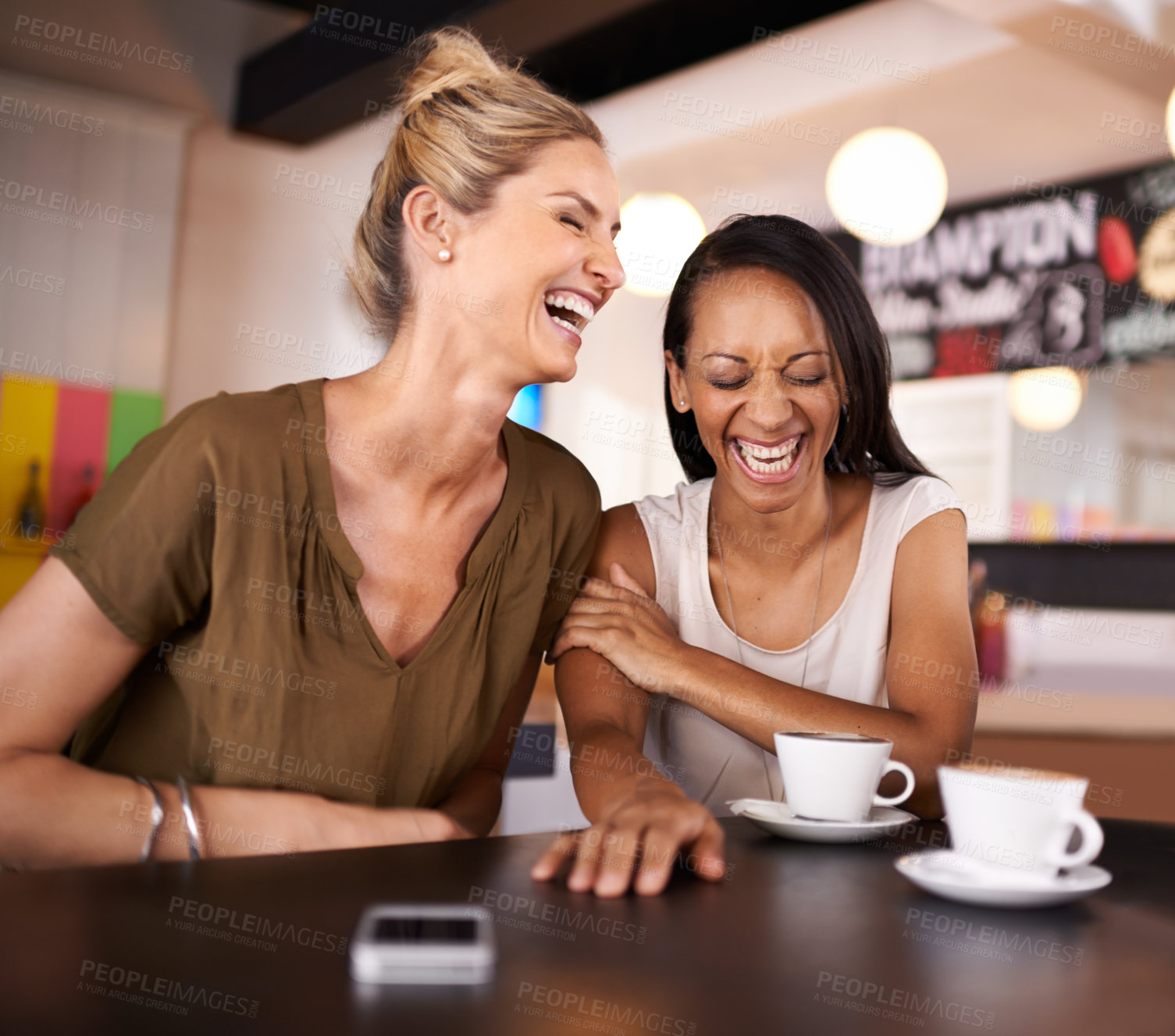 Buy stock photo Shot of two friends hanging out at a coffee shop together