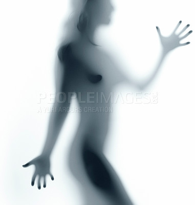 Buy stock photo Naked female body behind a white semi-clear screen. Silhouette shadow isolated against a white background. Sexy and feminine body posing confidently and seductively in studio displaying sensuality