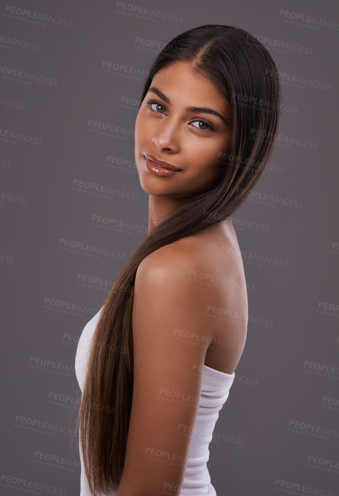 Buy stock photo Portrait, hair care and beauty of woman in makeup, glow or shine isolated on gray studio background. Face, hairstyle and Indian model in cosmetics at salon for skincare treatment, hairdresser or body