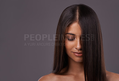 Buy stock photo A young woman with sleek hair posing in studio