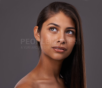 Buy stock photo Hair care, beauty and skincare of woman in makeup, shine and thinking isolated on a gray studio background. Hairstyle, cosmetics and young Indian model at hairdresser, salon and facial treatment