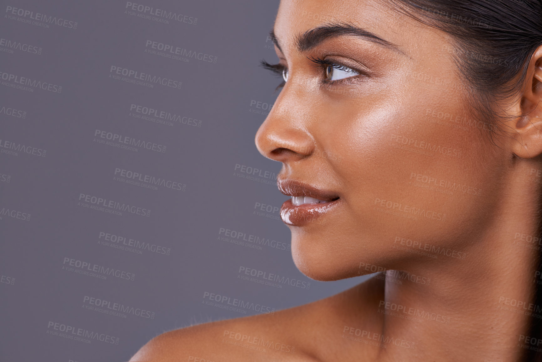 Buy stock photo Skincare, cosmetics and woman with makeup, shine and grooming routine on grey studio background. Person, model and girl with dermatology or luxury with treatment or foundation with glow or aesthetic