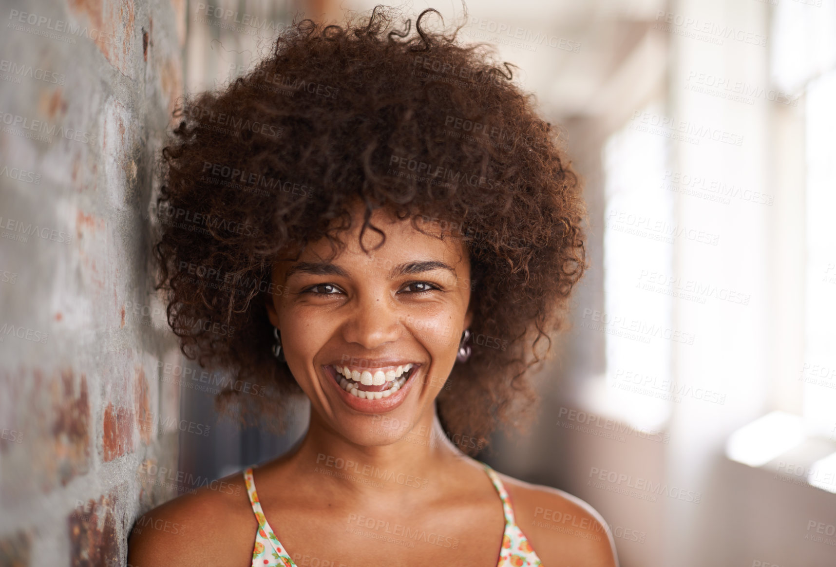 Buy stock photo Portrait, smile and woman by brick wall at university for education, learning or funny laugh in corridor alone. Face,  student and happy girl in hallway of college for profile picture in South Africa
