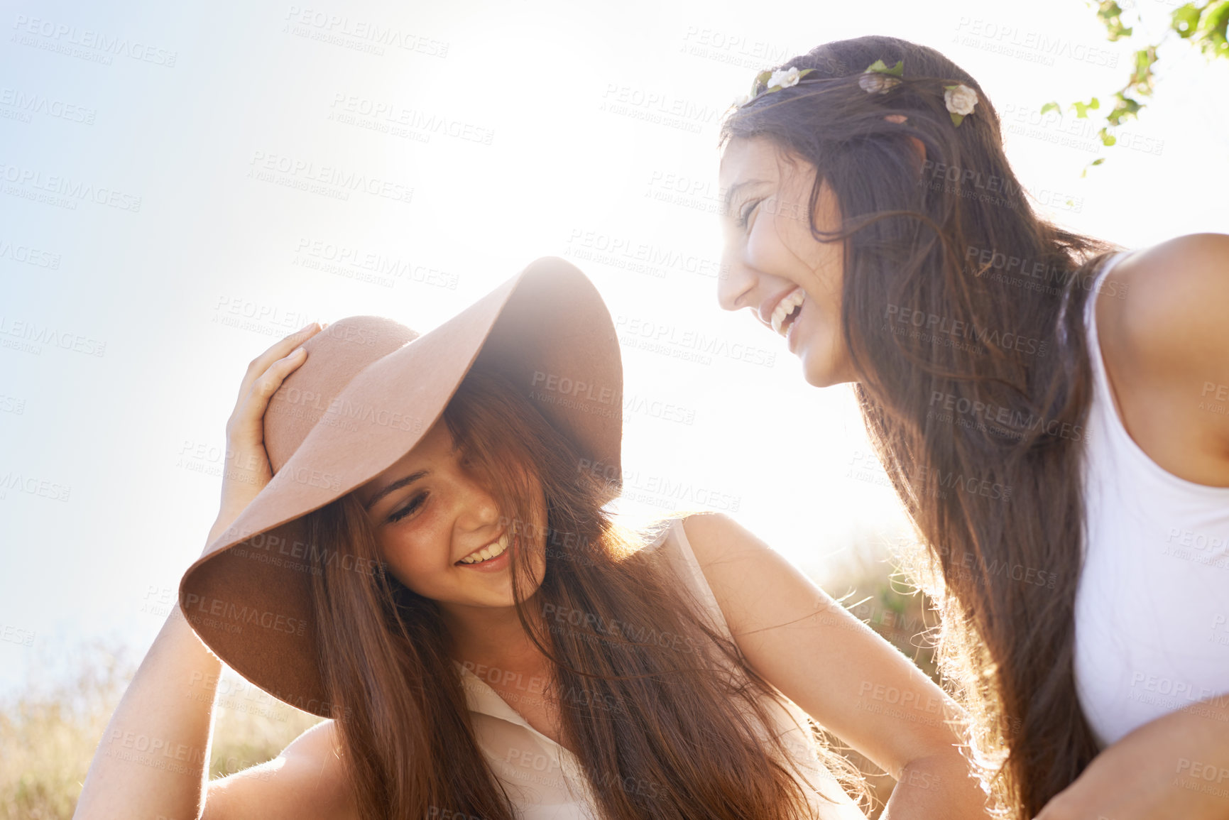 Buy stock photo Women, friends and outdoor in summer hat for travel, holiday and vacation together in sunshine. Happy and young people in countryside for fashion, talking and laughing in nature with cool style