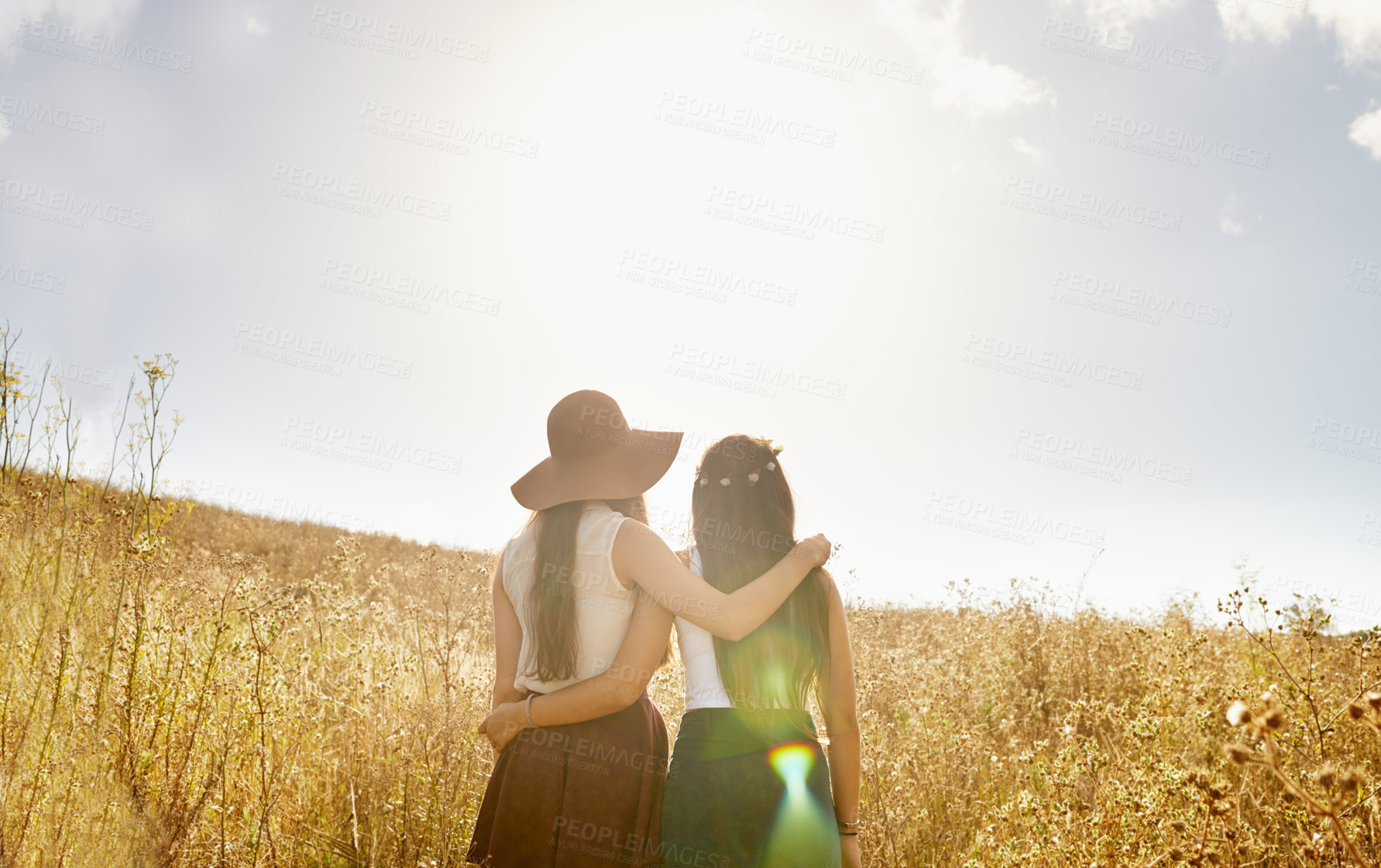 Buy stock photo Friends, walking and hug in summer nature on holiday or journey on vacation for adventure. Women, back and embrace outdoor together in sunshine on field, trekking on hill or travel environment