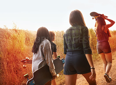 Buy stock photo Summer, nature and friends walking with skateboard on path in countryside or exercise on holiday or vacation. Women, hiking and relax outdoor together on trail, trekking on hill or travel environment
