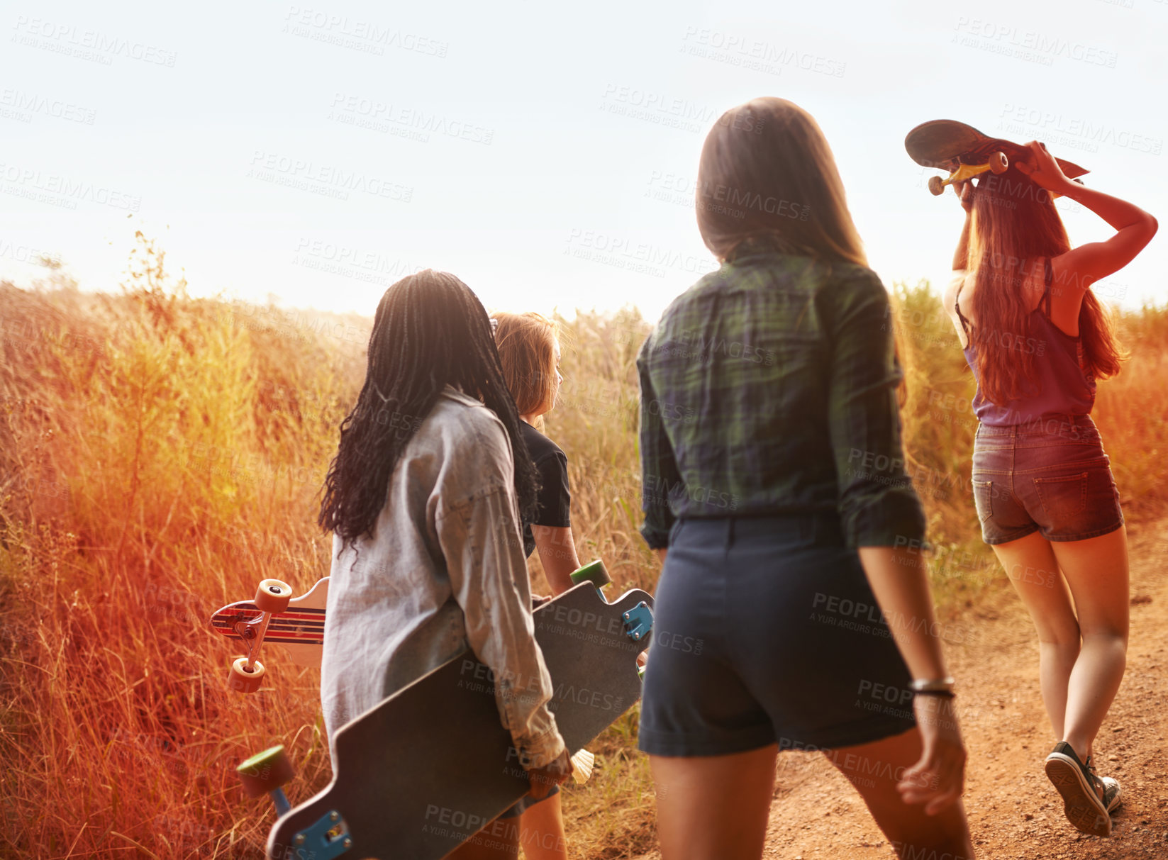 Buy stock photo Summer, nature and friends walking with skateboard on path in countryside or exercise on holiday or vacation. Women, hiking and relax outdoor together on trail, trekking on hill or travel environment