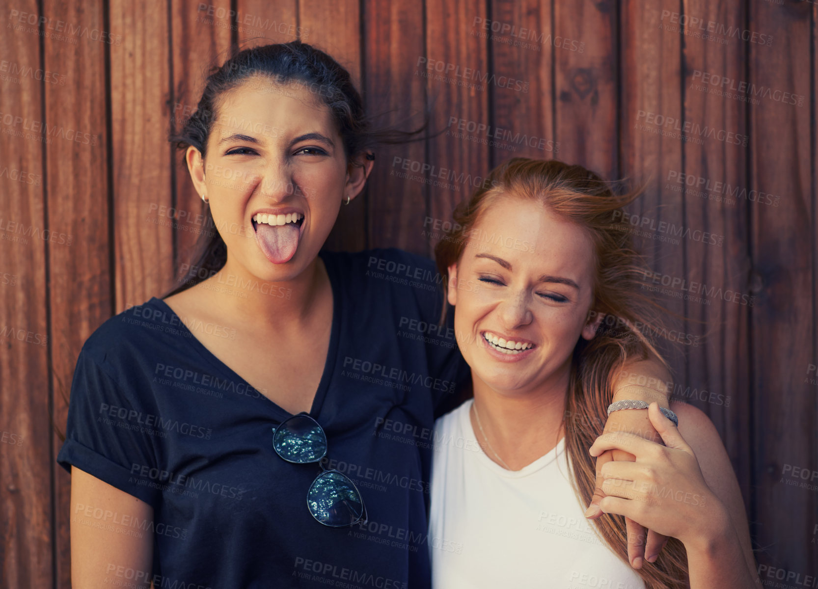 Buy stock photo Portrait, tongue out and woman friends on wooden background together for bonding or relationship. Love, funny face or laughing and happy young people having fun with fashion in summer for holiday