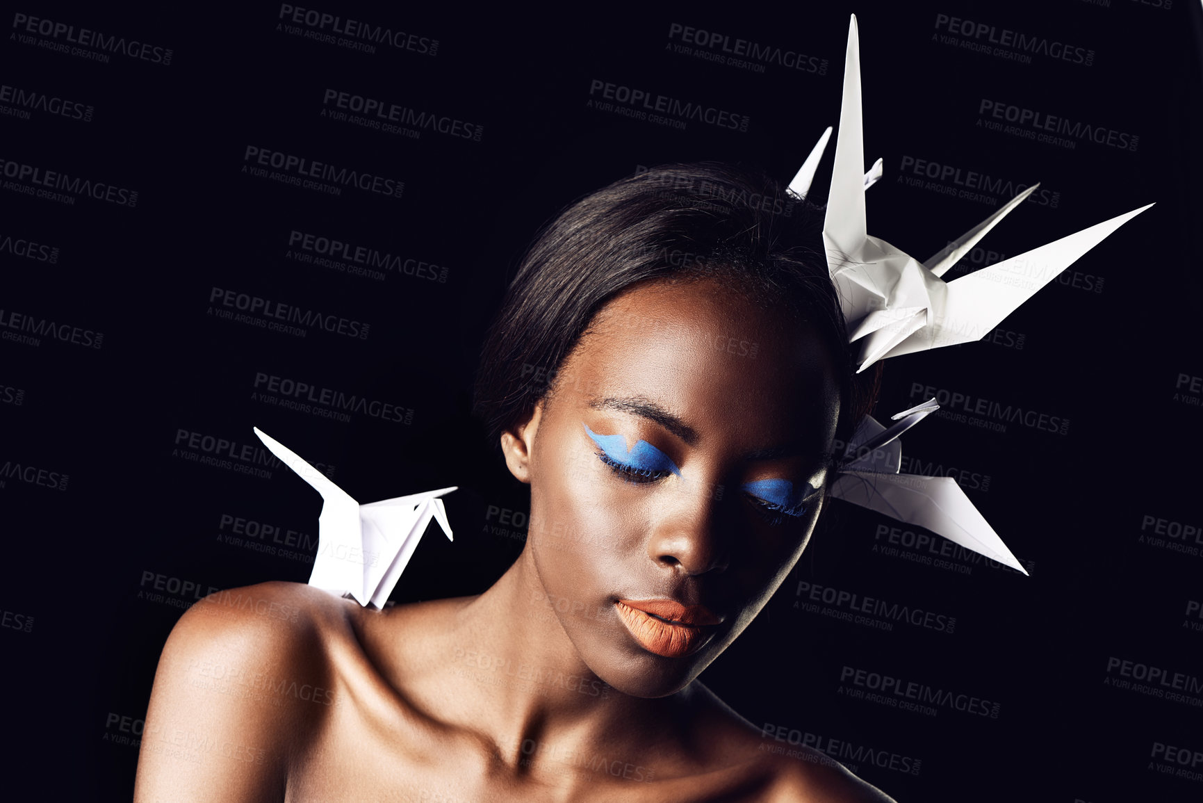 Buy stock photo Black woman, makeup and fine art with beauty, cosmetics or origami birds on a dark studio background. Closeup or face of African female person or model with dove or blue eye shadow on mockup space