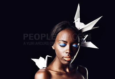 Buy stock photo Black woman, makeup and fine art with beauty, dove or origami birds on a dark studio background. Closeup or face of African female person or model with creative cosmetics or eyeshadow on mockup space