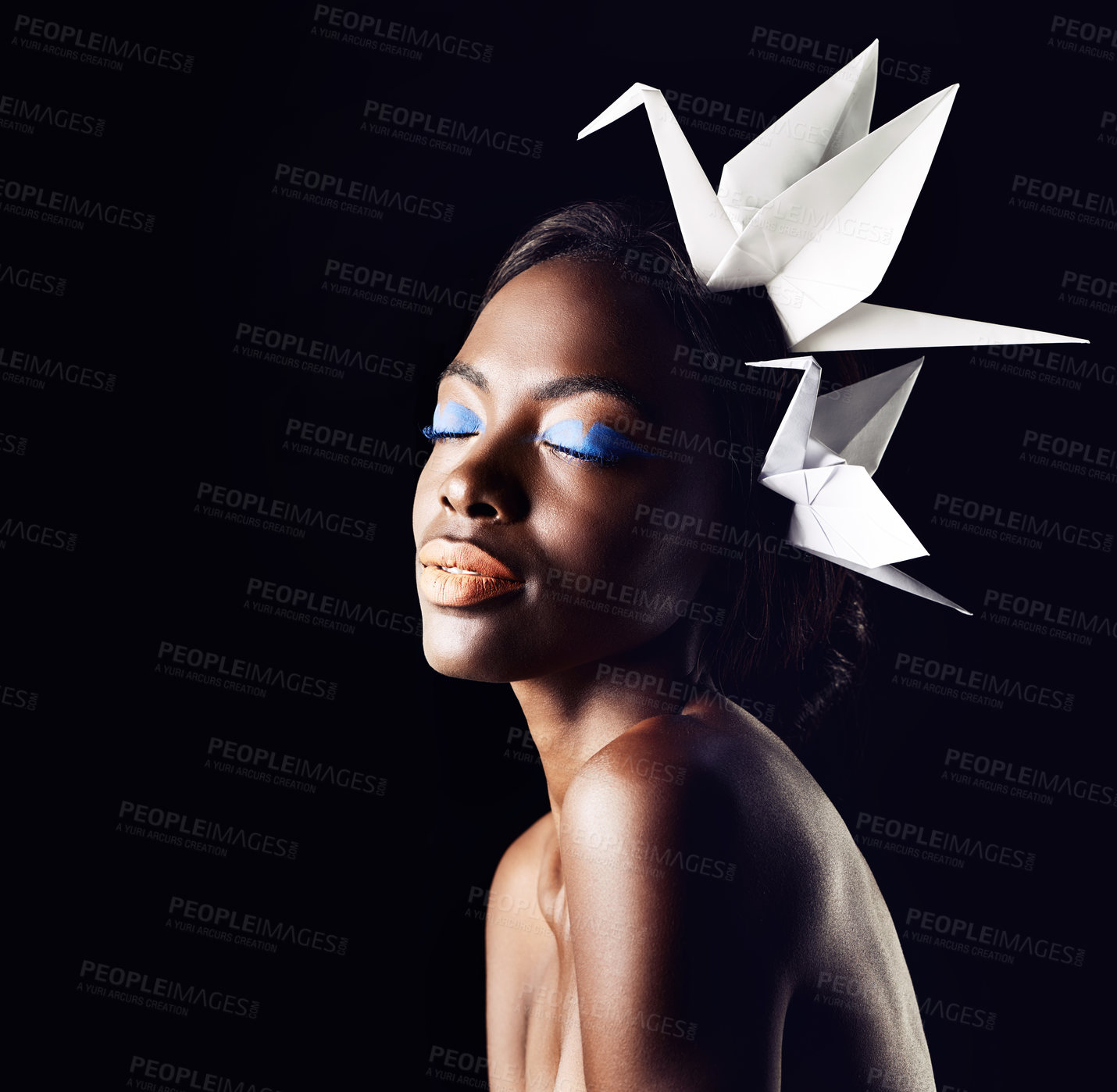 Buy stock photo Cropped shot of a beautiful ethnic woman posing with origami birds on her head